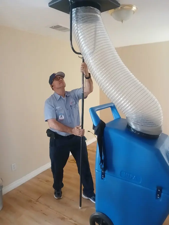 Furnace Tune-Up technician using HEPA equipment in Roswell